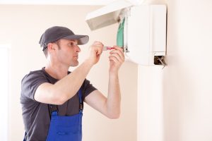 HVAC-technician-working-on-a-ductless-air-handler
